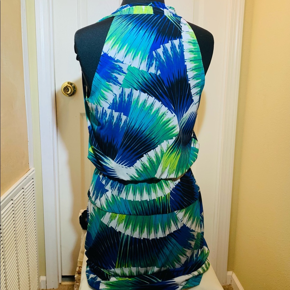 Sleeveless Faux wrap top with peplum effect. Gorgeous jewel tones